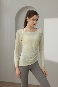 Detail of light yellow jacquard yoga top with side drawstring and mesh texture for women