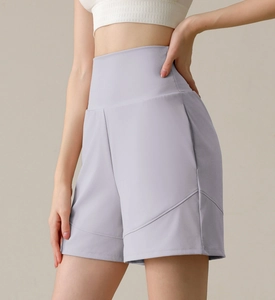 Close-up of light purple high-waisted yoga shorts with wide waistband and seam detailing