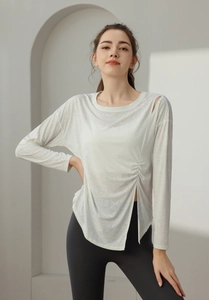 Close-up of white jacquard yoga top showing shoulder cutout and drawstring detail