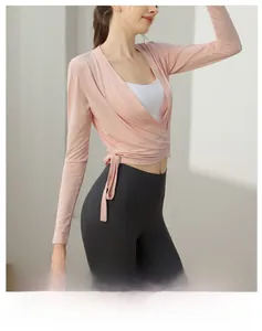 Detail of pink tie-front long sleeve yoga top with side knot and v-neck design