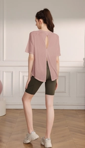 Detailed back view of pink yoga top featuring a stylish slit cutout and breathable fabric