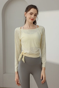 Detail of light yellow jacquard mesh yoga top with side tie-up and pleated design