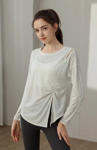 Close-up of white yoga top featuring stylish cutout shoulder and side drawstring details