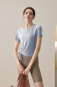 Detail of light blue yoga t-shirt featuring adjustable side drawstring and ruched design