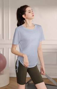 Detail of light blue yoga t-shirt with side drawstring and breathable athletic fabric