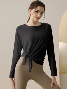 Women's black long sleeve yoga top with side tie knot and quick-dry breathable fabric