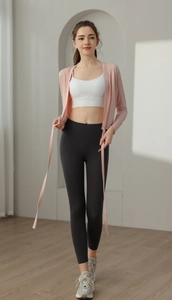 Detail of pink tie-front yoga cardigan paired with high-waisted gym leggings on a model
