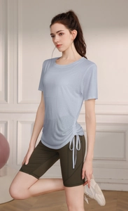 Detail view of Tencel yoga top featuring adjustable side drawstring and ruched design texture