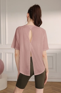 Detail view of pinkish-purple yoga top showing the stylish split back design for breathability