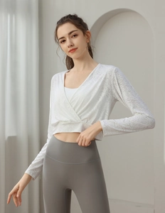 Macro detail of breathable white jacquard knit texture on women's long sleeve yoga crop top