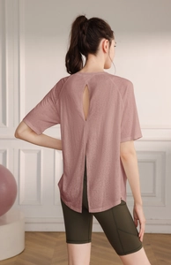 Detail of rose pink yoga top with water drop back cutout and split hem design
