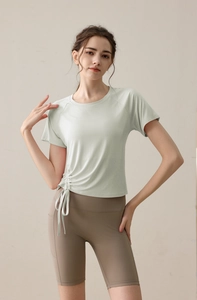 Detail of adjustable side drawstring and ruched design on light green yoga t-shirt