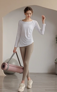 Detail of white nylon jacquard yoga top with ruched side and breathable mesh texture
