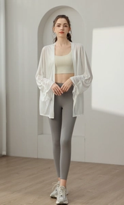 Three-piece yoga set with white sun-protection cardigan, beige bra, and grey leggings