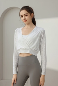 Close-up of women's white long sleeve yoga top with breathable hollow jacquard texture
