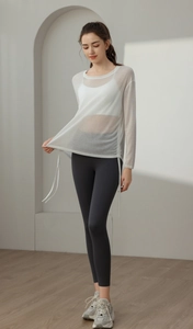 Detail of white semi-transparent yoga cover-up with drawstring sides and mesh texture