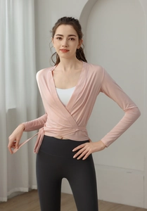Detail of pink tie-up long sleeve yoga cardigan with white racerback tank top layering