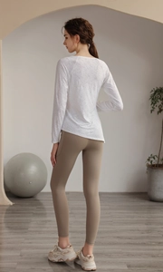Detail of white jacquard yoga top showing breathable fabric texture and slim fit design