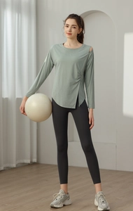 Detail view of light green jacquard yoga top showing side slit and shoulder cutout design