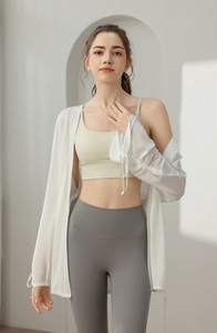 Detail of white breathable mesh yoga cover up with grey seamless high waist leggings
