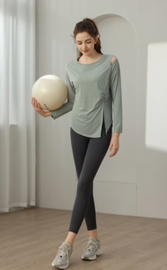 Detail of grey-green yoga top featuring shoulder cutout and side drawstring slit design