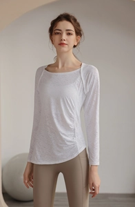 Detail of white jacquard yoga top with ruched waist and mesh breathable fabric