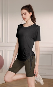 Detail of loose tencel yoga t-shirt with adjustable drawstring hem and olive green shorts