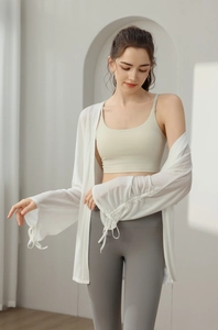 Detail of white breathable yoga cover-up showing adjustable drawstring cuff design