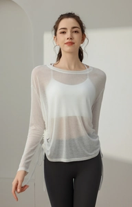 Detail of white mesh yoga cover-up showing side drawstring and breathable fabric