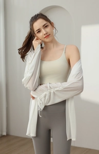 Detail of white semi-transparent yoga cover-up with drawstring cuffs on the sleeves