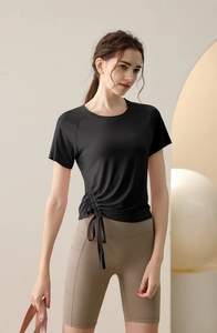 Detail of slim-fit yoga top with side drawstring and high-waist biker shorts with pockets
