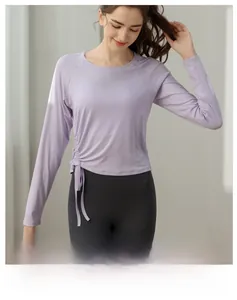 Detail of lavender slim fit yoga top with adjustable side drawstring and crew neck design