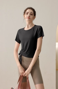 Detail of black drawstring fitness t-shirt with adjustable side ruching and yoga shorts