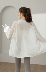 Detail of loose white breathable UV protection yoga cover-up jacket with sheer fabric