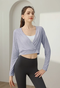 Detail of lavender wrap-style long sleeve yoga top with breathable jacquard texture fabric