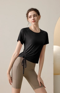 Detail of drawstring hem on black workout t-shirt and side pocket on beige cycling shorts
