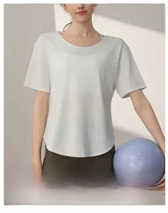 Detail of loose fit white quick-dry sports t-shirt with curved hem for yoga fitness
