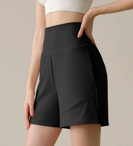 Close-up of black high-waisted nylon sports shorts with curved seam stitching details
