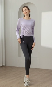 Detail of purple yoga top featuring adjustable side drawstring ruching and slim fit fabric