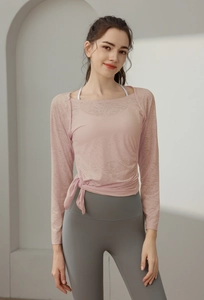 Close-up of pink jacquard yoga shirt featuring breathable texture and stylish side-tie knot