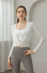 Detail of white wrap yoga cardigan with V-neck design and breathable athletic fabric