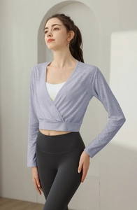Detail of lavender wrap-style cropped sports top with V-neck and breathable knit texture