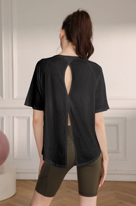 Detail of black breathable yoga top featuring an open back slit design for ventilation