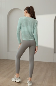 Vue de dos du haut de yoga en maille vert menthe léger et du legging de sport gris