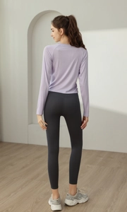 Slim fit lavender long sleeve yoga top featuring adjustable side drawstring details