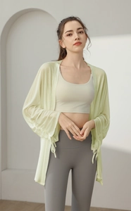 Detail of loose-fit light green sun-protection yoga jacket with drawstring cuffs