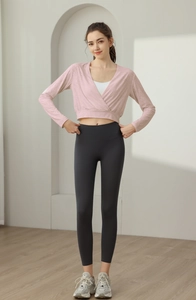 Detailed close-up of pink jacquard long-sleeve yoga top with cross V-neck design
