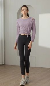 Detail of lavender purple yoga top with side tie knot and stylish shoulder cutout detail