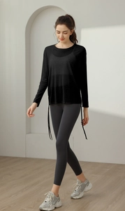 Detail of loose black yoga cover-up with drawstring side ties and long sleeves