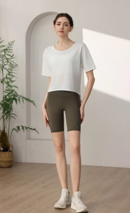 Detail view of the breathable white knit sports T-shirt and olive green cycling shorts